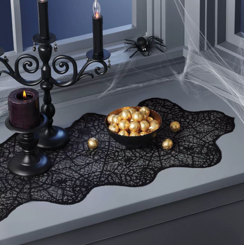 Be on the lookout for any actual spiders. <a href="https://goto.target.com/c/2055067/81938/2092?u=https%3A%2F%2Fwww.target.com%2Fp%2Flace-web-halloween-table-runner-hyde-38-eek-boutique-8482%2F-%2FA-78638822%3Fref%3Dtgt_adv_XS000000%26AFID%3Dgoogle_pla_df%26fndsrc%3Dtgtao%26DFA%3D71700000012806747%26CPNG%3DPLA_Seasonal%252BShopping_Local%26adgroup%3DSC_Seasonal%26LID%3D700000001170770pgs%26LNM%3DPRODUCT_GROUP%26network%3Dg%26device%3Dc%26location%3D9004054%26targetid%3Dpla-956047986400%26ds_rl%3D1246978%26ds_rl%3D1248099%26ds_rl%3D1247068%26gclid%3DCjwKCAjwiaX8BRBZEiwAQQxGx7leEBQXpieNm0wNQjBe93CkD8gOuHAGUaoSDnMnWhCKWTW9QNn4SRoCqoUQAvD_BwE%26gclsrc%3Daw.ds&amp;subid1=5&amp;subid2=halloween&amp;subid3=decor" target="_blank" rel="noopener noreferrer">Find it for $10 at Target</a>.