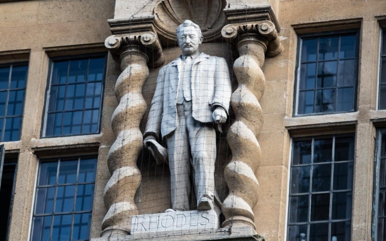 OXFORD, ENGLAND - MAY 25: Oriel Colleges statue of Cecil Rhodes at the University of Oxford on May 25, 2021 in Oxford, England. Today marked the first anniversary of the death of George Floyd, an American man killed by police in the US state of Minnesota, and whose death spurred the Black Lives Matter movement in the US, UK and elsewhere. The protesters marched to Oxford University's Oriel College, which announced last week that it would not be removing a statue of 19th-century imperialist and businessman Cecil Rhodes perched atop its entrance. Activists in the UK and South Africa have called for the removal of statues in his honour, arguing that Rhodes is the embodiment of white supremacy. (Photo by Laurel Chor/Getty Images) - Laurel Chor/Getty Images