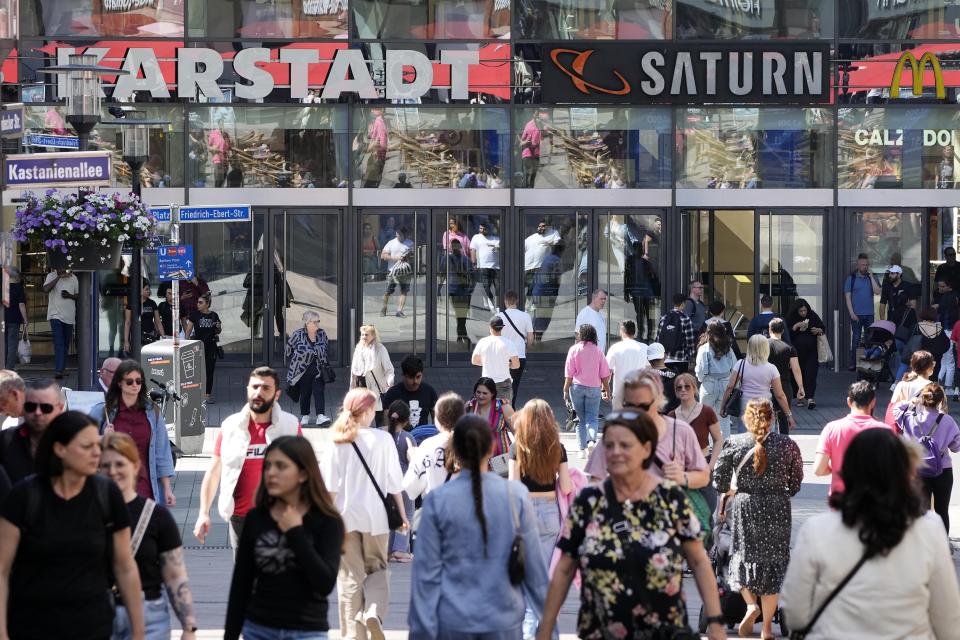 People walk on a shopping street in Essen, Germany, Wednesday, May 31, 2023. German inflation eased to 6.1% in May following several months of declines, even as Europe's biggest economy registered another painful increase in food prices of nearly 15%. (AP Photo/Martin Meissner)