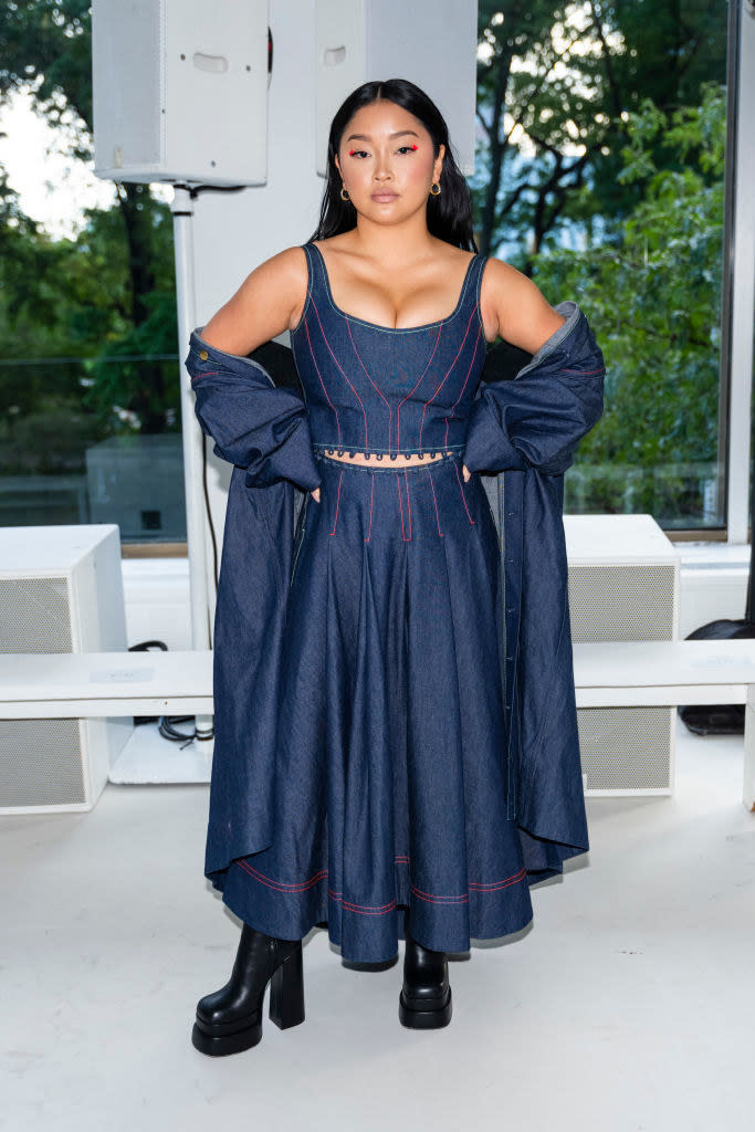 Lana Condor in a denim skirt and matching crop top and jacket