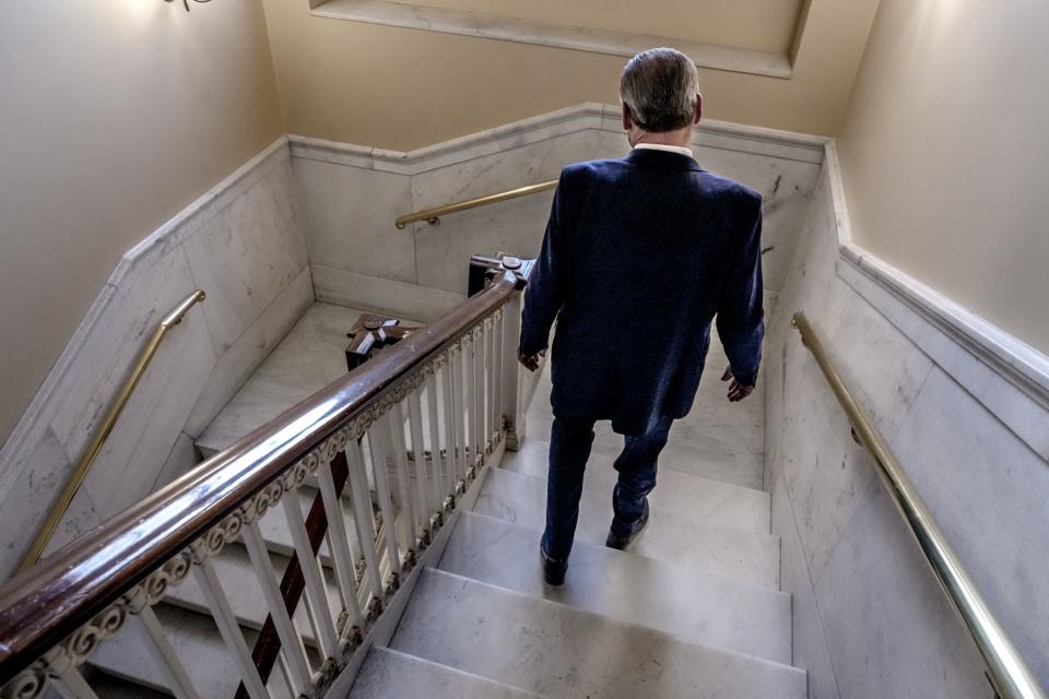 Senate President Dominick Ruggerio heads down a staircase in the State House. [David DelPoio/The Providence Journal]