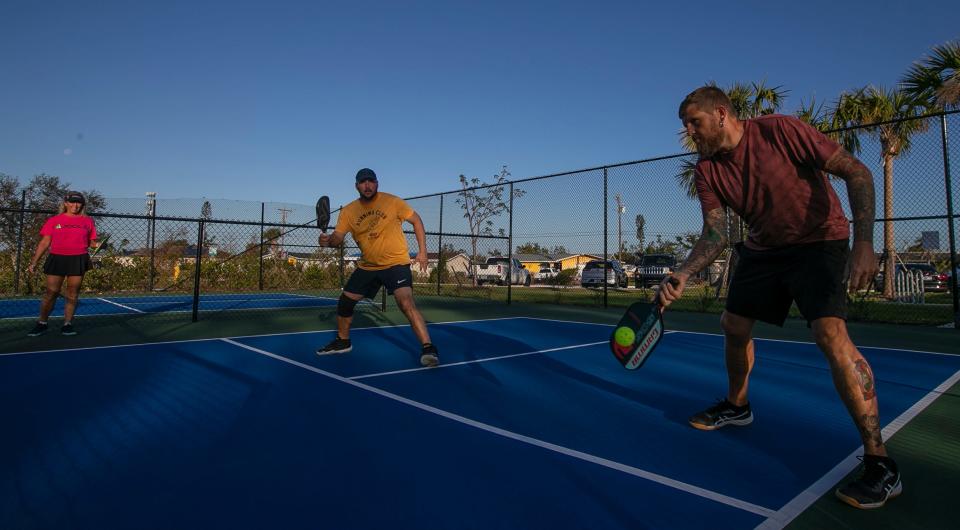 Jason Adams, right, plays a morning round of pickleball alongside Michael Reale on the courts at Giuffrida Park in Cape Coral.