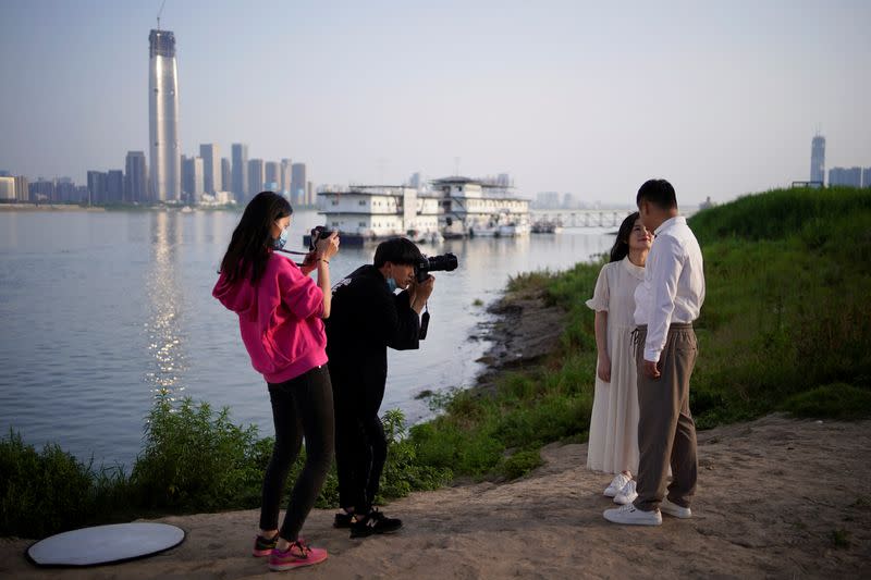 Peng Jing, 24, and Yao Bin, 28, pose for their wedding photography shoot after the lockdown was lifted in Wuhan