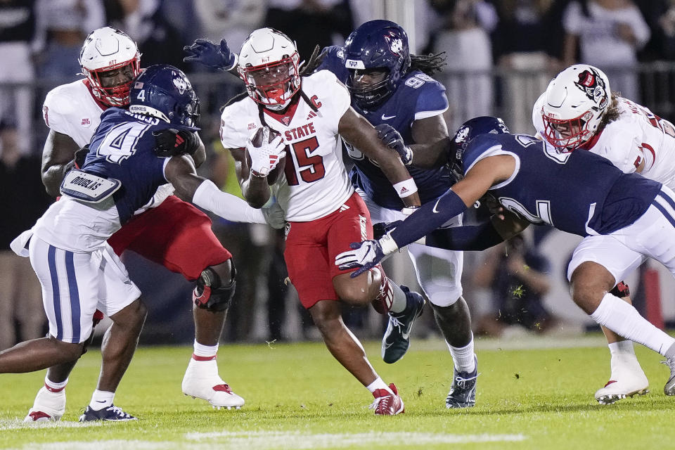 North Carolina State wide receiver Keyon Lesane (15) runs with the ball during the first half the team's NCAA college football game against UConn in East Hartford, Conn., Thursday, Aug. 31, 2023. (AP Photo/Bryan Woolston)