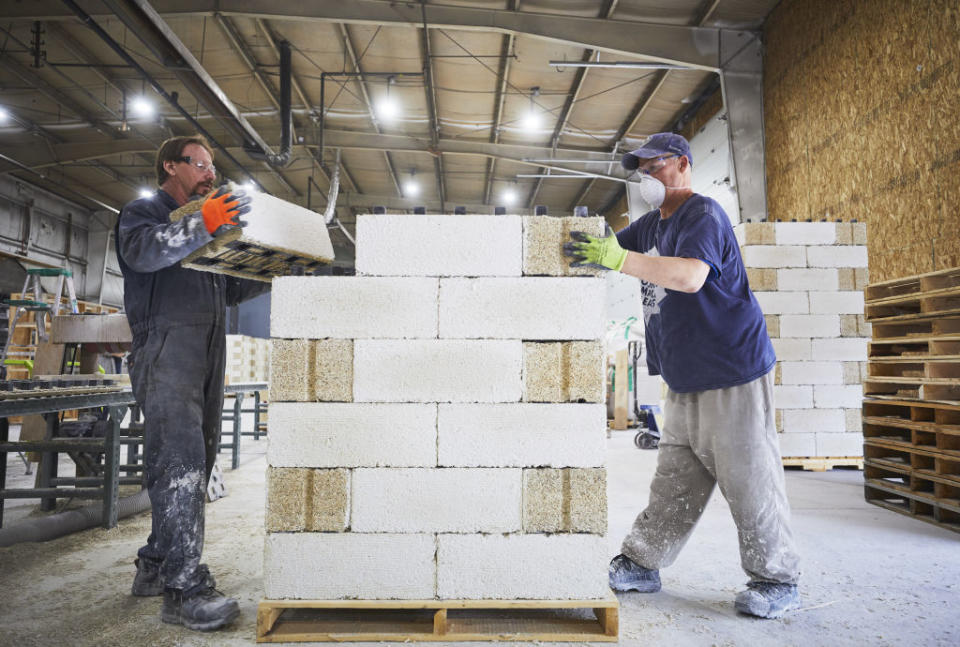 Workers stack hemp bricks at the JustBioFiber Structural Solutions manufacturing facility in Alberta, Canada, on Thursday, Aug. 1, 2019. Hemp, helps builders limit their carbon footprints.<span class="copyright">Todd Korol/Bloomberg—Getty Images</span>