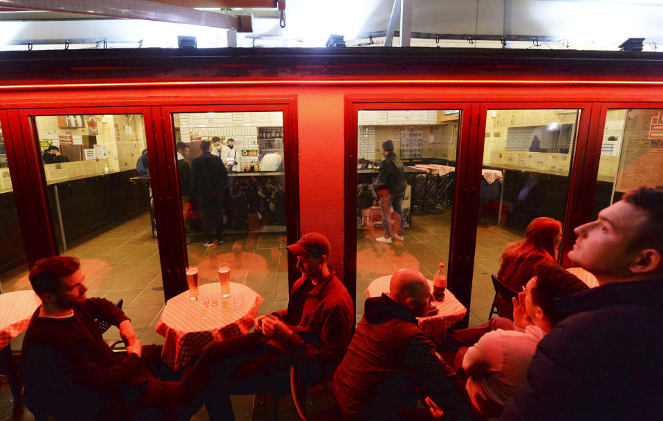 People gather and celebrate as bars, clubs and other establishments reopened in Poland after being closed for seven months, in Warsaw, Poland, Friday, May 14, 2021.(AP Photo/Czarek Sokolowski)