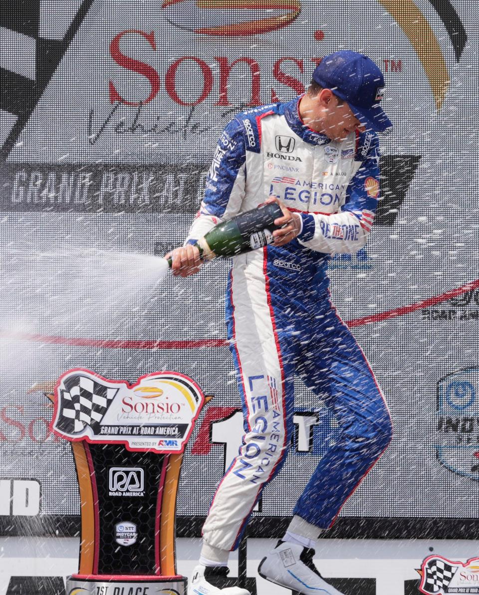 Sonsio Grand Prix winner Alex Palou sprays champagne following his victory Sunday at Road America.
