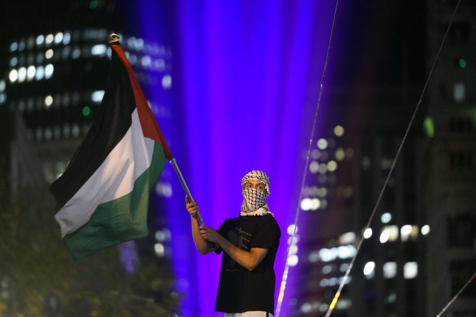 FILE - A demonstrator waves a Palestinian flag during a protest in opposition to the Israel-Hamas war in conjunction with the APEC Summit taking place on Nov. 14, 2023, in San Francisco. (AP Photo/Godofredo A. Vásquez, File)