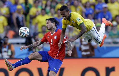 Chile's Mauricio Pinilla, left, and Brazil's Luiz Gustavo battle for the ball during match between Brazil and Chile. (Andre Penner/AP Photo)