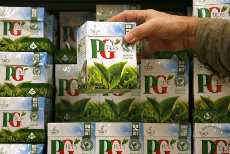 A shopper picks up a box of PG Tips tea bags at a supermarket in London February 6, 2008. REUTERS/Luke MacGregor