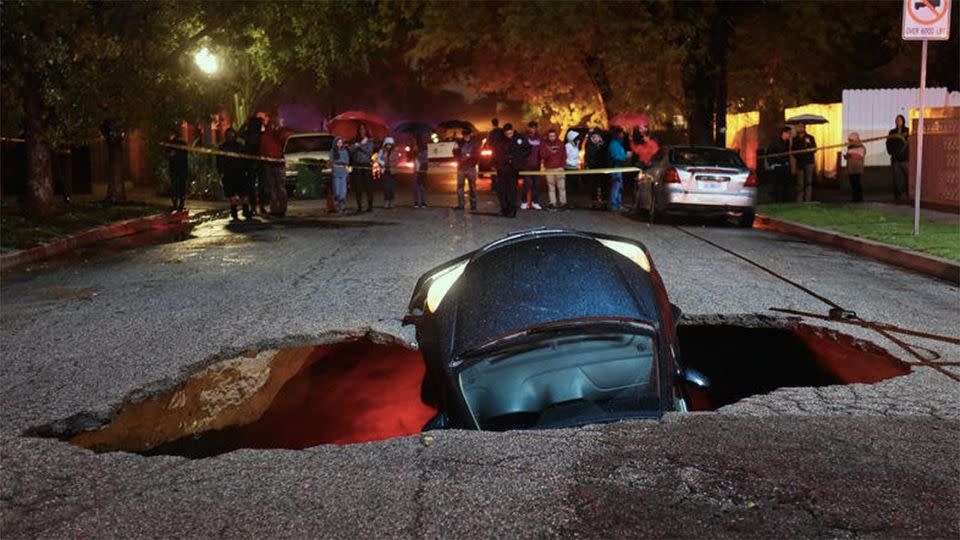 A woman whose car fell to the bottom of the sinkhole told the LA Fire Deparment that she 