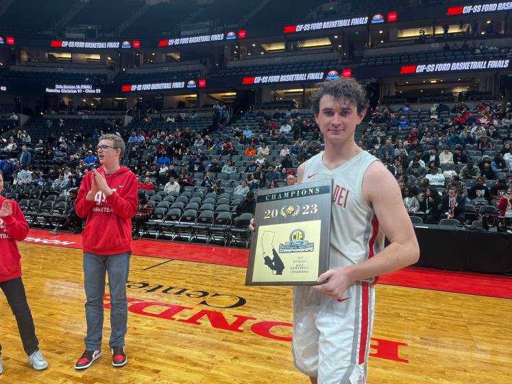 Mater Dei's Zack Davidson holds the boys' basketball Southern Section Division I championship plaque.