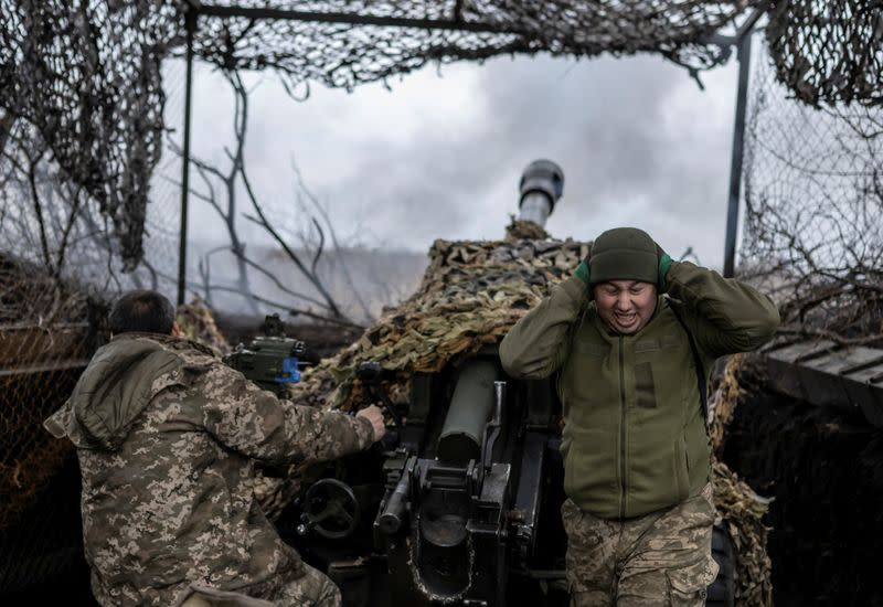 Ukrainian service members fire a L119 howitzer towards Russian troops near the front line town of Bakhmut