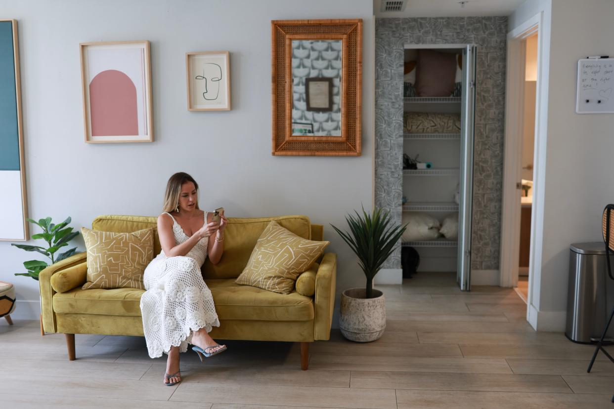 Mari Juliette, the owner of Mari Juliette Real Estate, uses her phone to give a TikTok tour of a condo she is selling on April 26, 2024, in Miami, Florida.