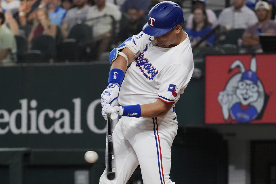 Texas Rangers Nathaniel Lowe hits a home run during the third inning of a baseball game against the San Diego Padres in Arlington, Texas, Tuesday, July 2, 2024. Texas Rangers Josh Smith also scored on the play. (AP Photo/LM Otero)