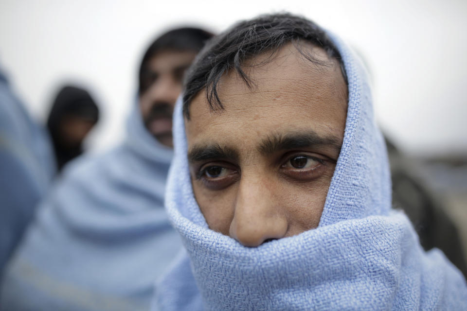 CORRECTING YEAR TO 2018 - In this Sunday, Nov. 18, 2018 photo a migrant wrapped in a blanket waits for food distribution at a camp in Velika Kladusa, Bosnia, close to the border to Croatia. The approach of the tough Balkan winter spells tough times for the migrants that remain stuck in the region while trying to reach Western Europe, with hundreds of them staying in make-shift camps with no heating or facilities.(AP Photo/Amel Emric)