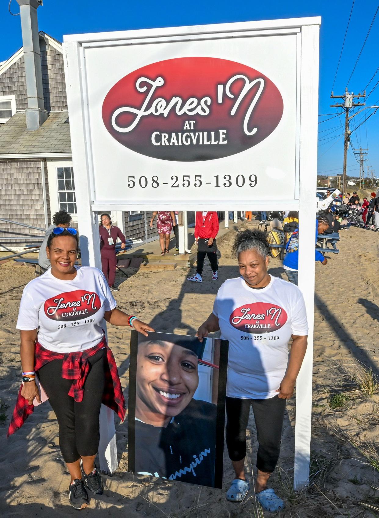 Jeneen Texeira (left) and Paulene Jones at Jones' N at Craigville with a photo of Paulene's daughter, Junelle Jones Saunders, who died a year ago.