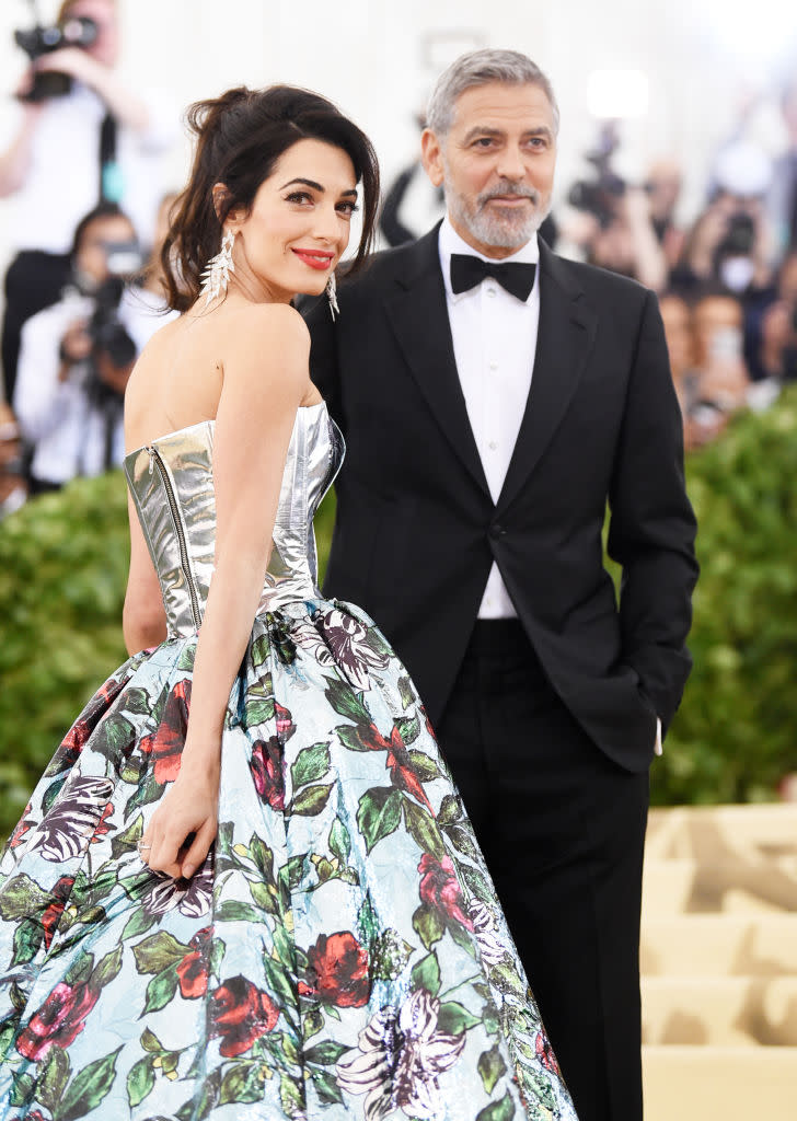 Amal Clooney and George Clooney walk the red carpet at the “Heavenly Bodies: Fashion & The Catholic Imagination” Costume Institute Gala at the Metropolitan Museum of Art on May 7, 2018 in New York City. (Photo: Jamie McCarthy/Getty Images)