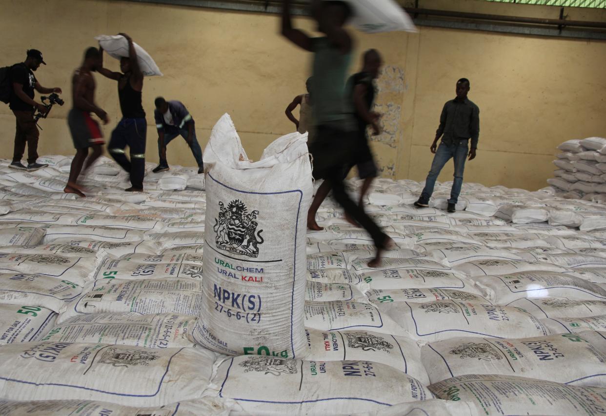 People collect bags of Russian fertiliser in Lilongwe on Monday (AP Photo/Gregory Gondwe)