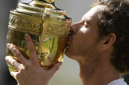 Britain Tennis - Wimbledon - All England Lawn Tennis & Croquet Club, Wimbledon, England - 10/7/16 Great Britain's Andy Murray kisses the trophy as he celebrates winning the mens singles final against Canada's Milos Raonic REUTERS/Tony O'Brien