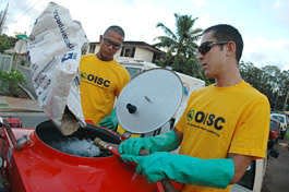 Field technicians with the Oahu Invasive Species Committee Brian Caleda and Daniel Tsukayama, mix a lethal mix of citric acid and water, before dousing coqui frogs. The loudly shrieking amphibians are menacing Hawaii's economy.