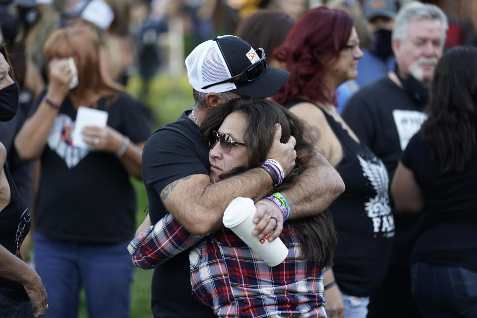 Jimmy Long, left, embraces Debby Allen, mother of victim Christopher Roybal, during a ceremony Thursday, Oct. 1, 2020, on the anniversary of the mass shooting three years earlier in Las Vegas. The ceremony was held for survivors and victim's families of the deadliest mass shooting in modern U.S. history. (AP Photo/John Locher)