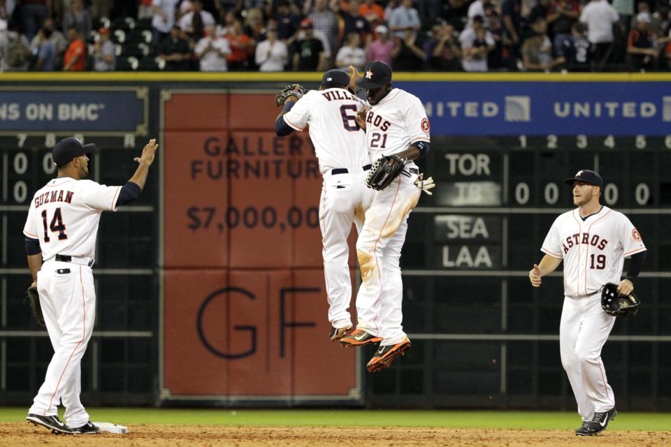 Houston Astros' Jesus Guzman (14), Jonathan Villar (6), Dexter Fowler (21) and Robbie Grossman (19) celebrate a 6-2 victory over the New York Yankees in a baseball game, Tuesday, April 1, 2014, in Houston. (AP Photo/Patric Schneider)