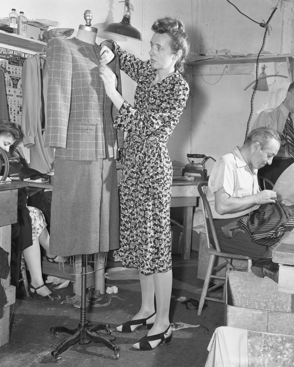 (Original Caption) Designer at Work. New York: Designer Clare McCardell putting the nearly finished suit on a dummy. After being pinned and finger-dressed into shape, it goes back into the work room to receive finishing touches.