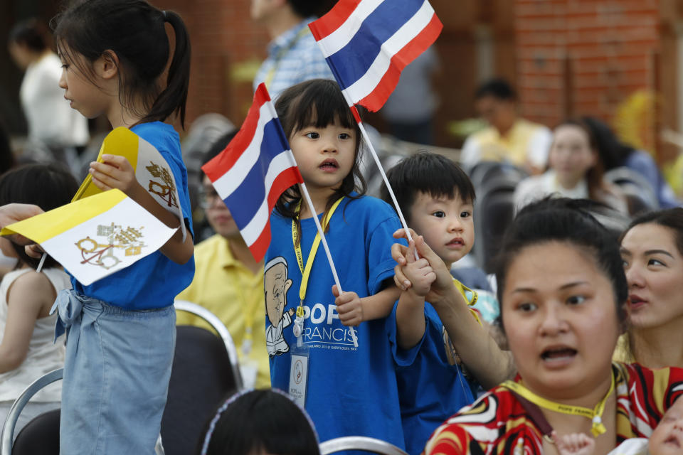 Children wait for the arrival of Pope Francis at Saint Louis Hospital in Bangkok, Thailand, Thursday, Nov. 21, 2019. Pope Francis called for migrants to be welcomed and for women and children to be protected from exploitation, abuse and enslavement as he began a busy two days of activities in Thailand on Thursday. (AP Photo/Manish Swarup)