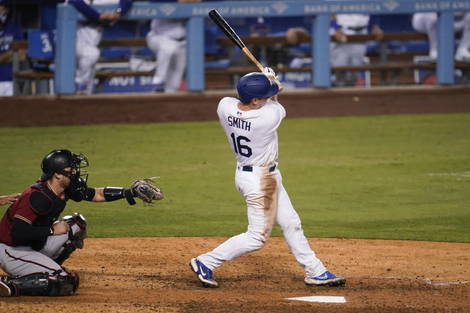 Los Angeles Dodgers' Will Smith watches his single that drove in the winning run during the 10th inning of the team's baseball game against the Arizona Diamondbacks on Wednesday, Sept. 2, 2020, in Los Angeles. (AP Photo/Marcio Jose Sanchez)