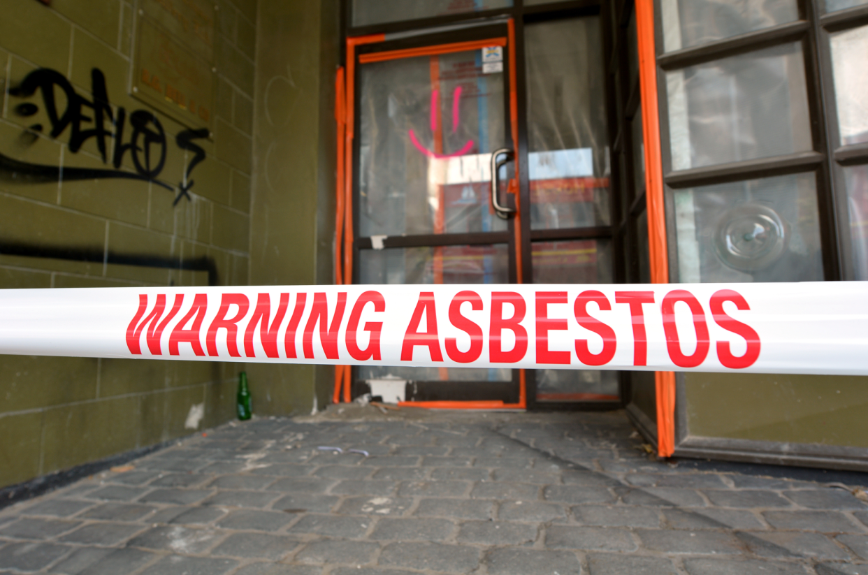 Asbestos Removal, 'Warning Abestos' Tape Sign in Front of a House