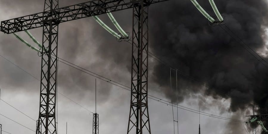 Smoke rises over a high-voltage power line at the site of a missile attack in Kharkiv, March 22