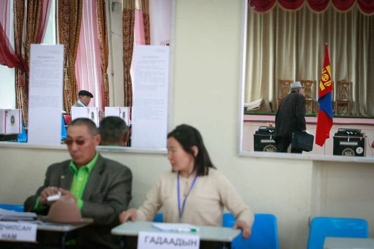 Mongolian voters fill in forms at a polling station in Ulan Bator, on June 26, 2013. Mongolians are voting in a presidential election pitting the front-running incumbent against a champion wrestler and a woman, amid calls for a fairer distribution of the former Soviet satellite's spectacular mining wealth