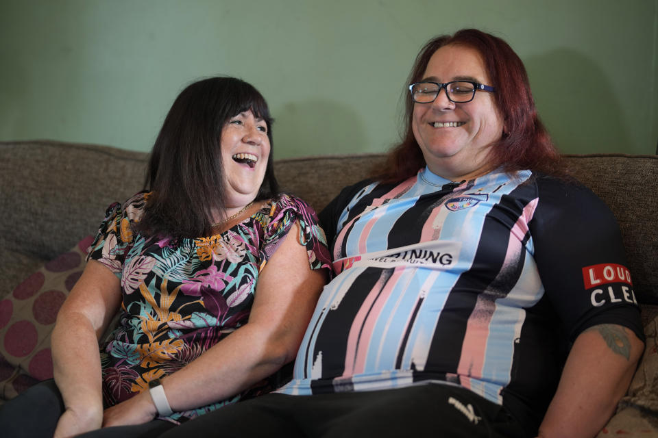 Avril Clark, left, and Lucy speak during an interview at their house in London, Tuesday, June 11, 2024. Avril Clark operates the group Distinction Support, a U.K.-based global online network that helps people whose partner went through or is undergoing a gender transition. Her spouse, a British soccer referee at the time, came out publicly as transgender in 2018, changed her name to Lucy and brought the couple much attention. Avril Clark says that until then, they kept their arrangement private and "lived a double life" for 15 years. (AP Photo/Kin Cheung)