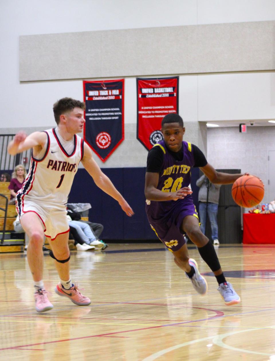 Aiden Walter of Monty Tech drives past Brian Morse in the Bulldogs' game against North Middlesex on Dec. 27, 2023.