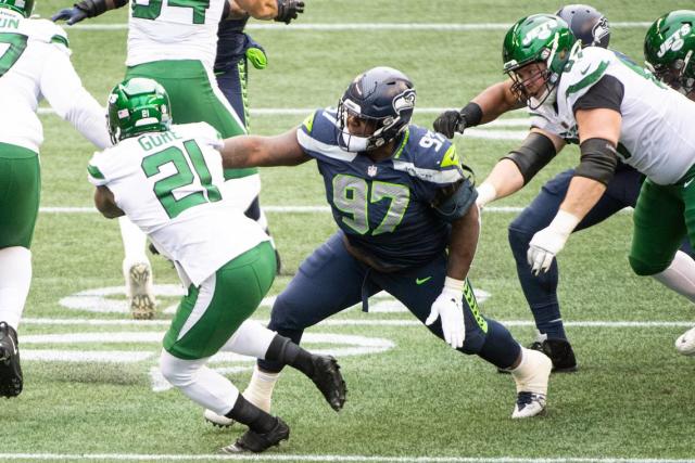 Seattle Seahawks defensive tackle Poona Ford tackles New York Jets running back Frank Gore during the first quarter. The Seattle Seahawks played the New York Jets in a NFL football game at Lumen Field in Seattle, Wash., on Sunday, Dec. 13, 2020.