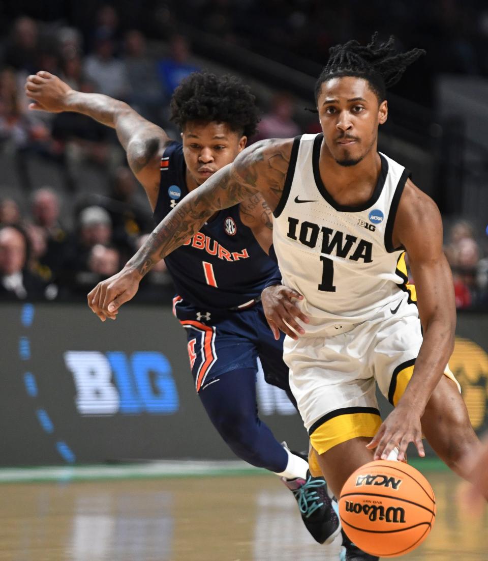 Former Iowa basketball player Ahron Ulis drives against Auburn in an NCAA Tournament game in March.