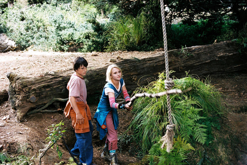 kids grabbing a rope in a clearing