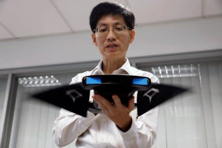 NUS Department of Mechanical Engineering researcher Chew Chee Meng showcases their aquatic robot manta ray