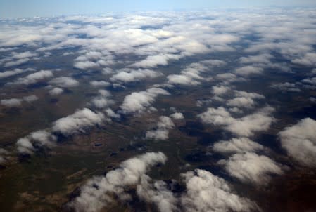 Clouds and land are seen from an atmospheric research aircraft en route to the Norwegian Sea from northern Sweden