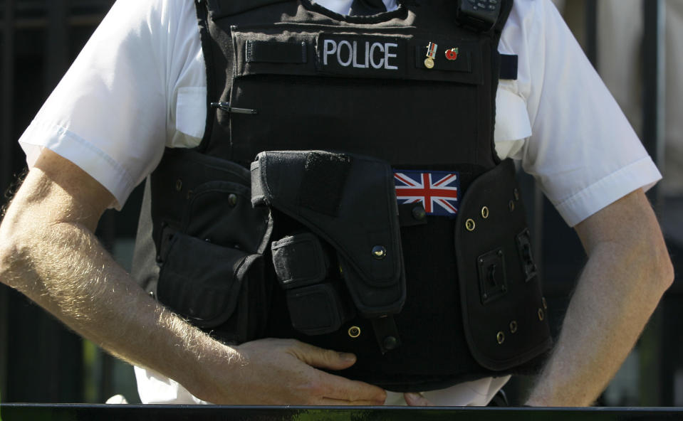 A police officer keeps watch in Westminster near the London 2012 beach volleyball venue, in London, Wednesday, March 28, 2012. Britain's spy agencies and police have planned for a dizzying array of security nightmares surrounding the Olympics a coordinated terror attack like the 2005 suicide bombings, a dirty bomb, a cyberattack and hoaxes designed to scatter personnel.(AP Photo/Kirsty Wigglesworth)