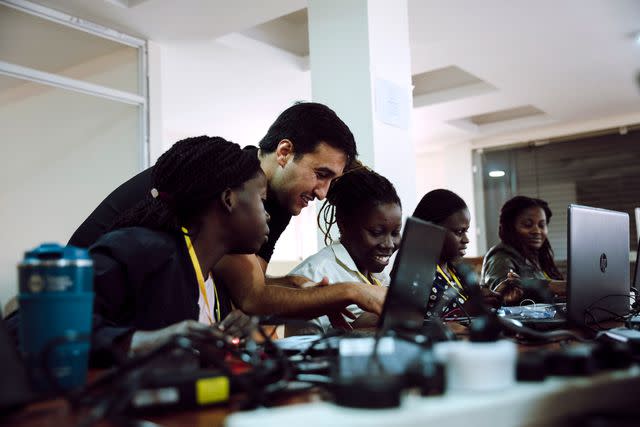 <p>Cadence</p> A Cadence employee supporting STEM learning during a Team4Tech global volunteer immersion program in Kampala, Uganda.