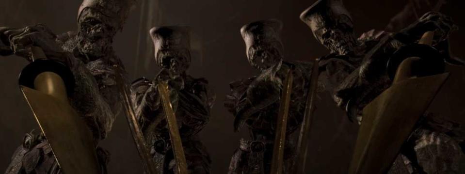 Mummy soldiers aim swords and spears at the camera