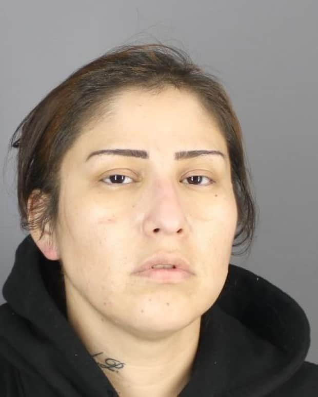 The Prince Albert Police Service says they have taken Loretta Lynn Sakebow into custody. She was wanted on a warrant in connection with second degree murder.  (Prince Albert Police Service/Handout - image credit)