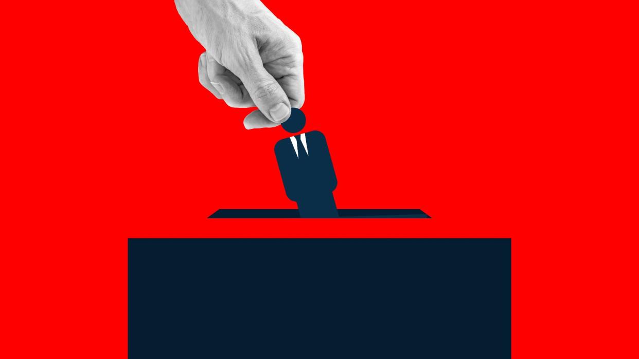  Illustration featuring a human hand placing an icon of man wearing suit into the ballot box. 