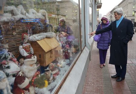 U.S. Secretary of State John Kerry points to the window of a shop while walking on Arbat Street for souvenir shopping with Celeste Wallander of the National Security Council in Moscow on December 15, 2015. REUTERS/Mandel Ngan/Pool