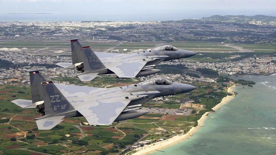 F-15Cs fly over Okinawa, home of Kadena Air Base, which not long ago lost its large contignet of F-15C/Ds. Now that is being rectified via two new squadrons of F-15EXs. (USAF)