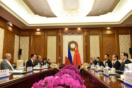 Philippine Foreign Affairs Secretary Alan Peter Cayetano, second from left, talks with Chinese Foreign Minster and State Counselor Wang Yi, second from right, during their meeting at the Diaoyutai State Guesthouse in Beijing, China March 21, 2018. Parker Song/Pool via REUTERS