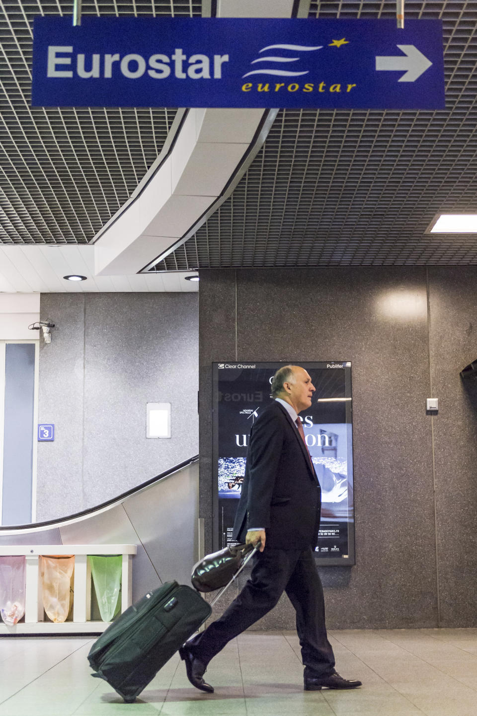 FILE - In this Oct. 9, 2015 file photo, a commuter walks towards the Eurostar terminal at the Brussels South rail station, in Belgium. A study commissioned by the environmental group Greenpeace shows that over one-third of the busiest short-haul flights in Europe have viable train alternatives which are far less polluting. The group called on European governments Wednesday, Oct. 27, 2021, to boost train travel so fewer polluting planes are flying over the continent. (AP Photo/Geert Vanden Wijngaert, file)