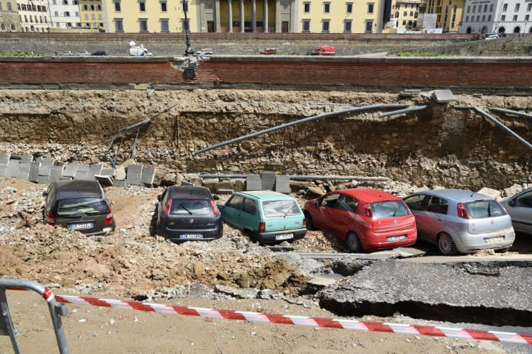 Damaged cars along the Arno river where the embankment collapsed in Florence, on May 25, 2016